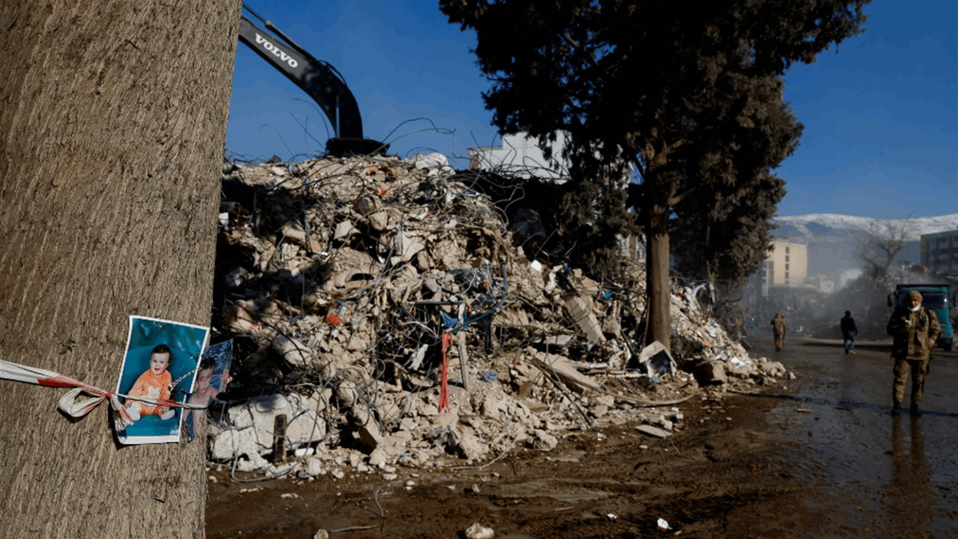 Photos tied to tree of missing boys highlight painful search for earthquake victims