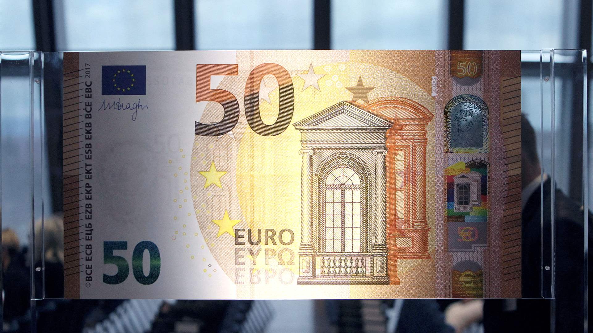 Euro eases, but robust services data stems losses