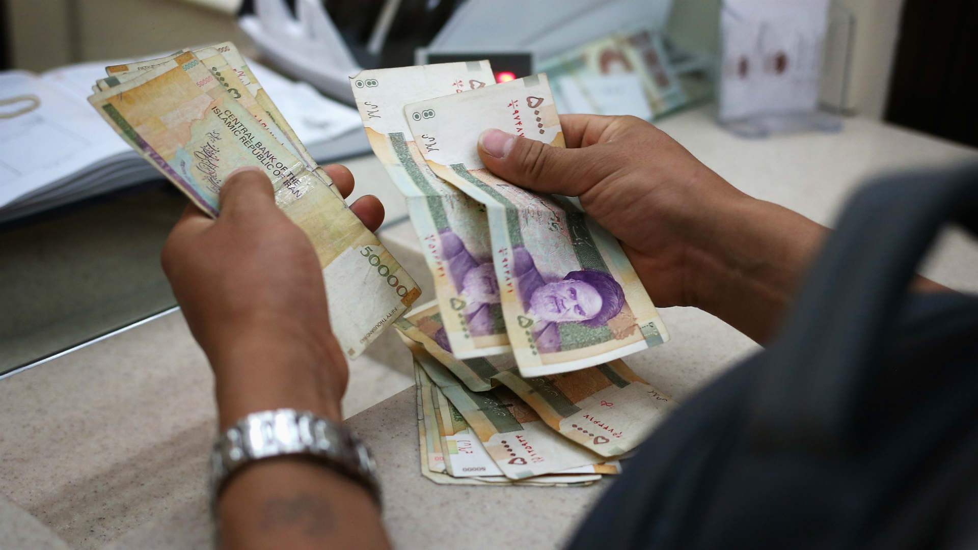 Iran's currency slides to record low as savers buy dollars