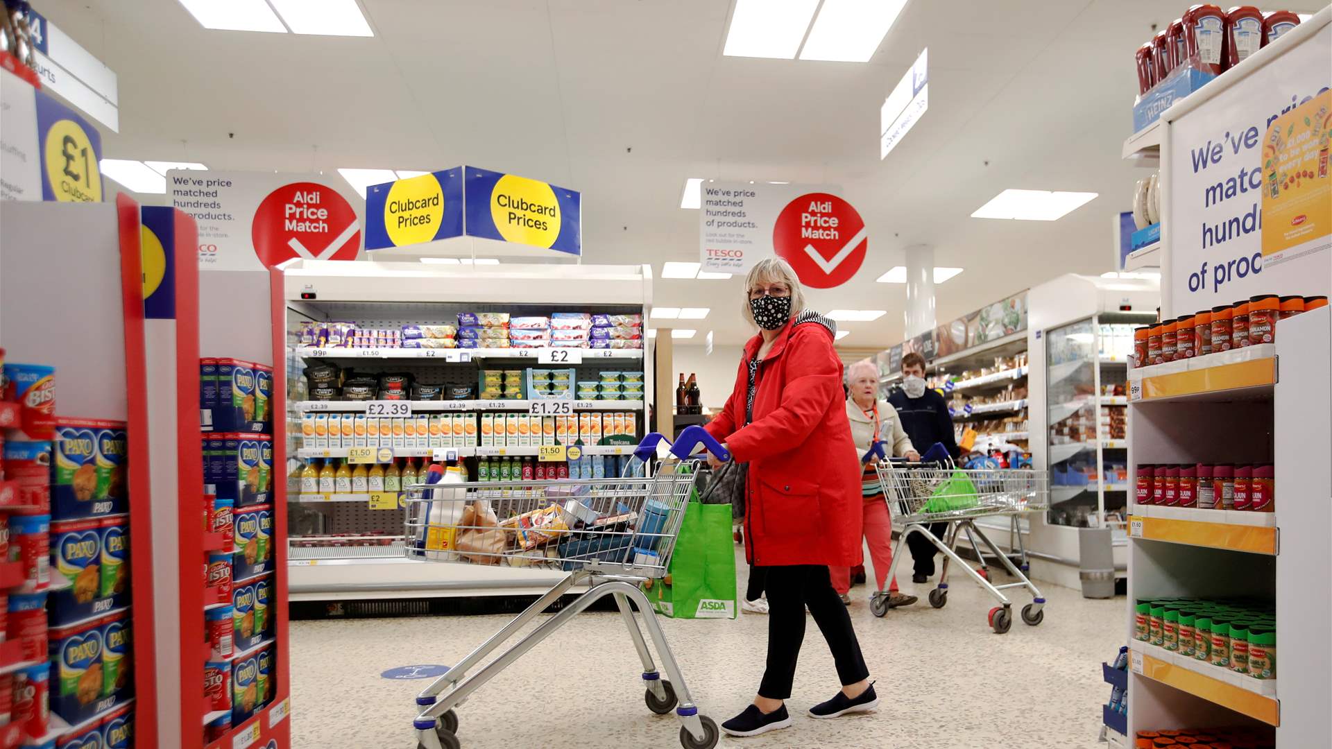 UK supermarket Tesco's profit halves as inflation bites
