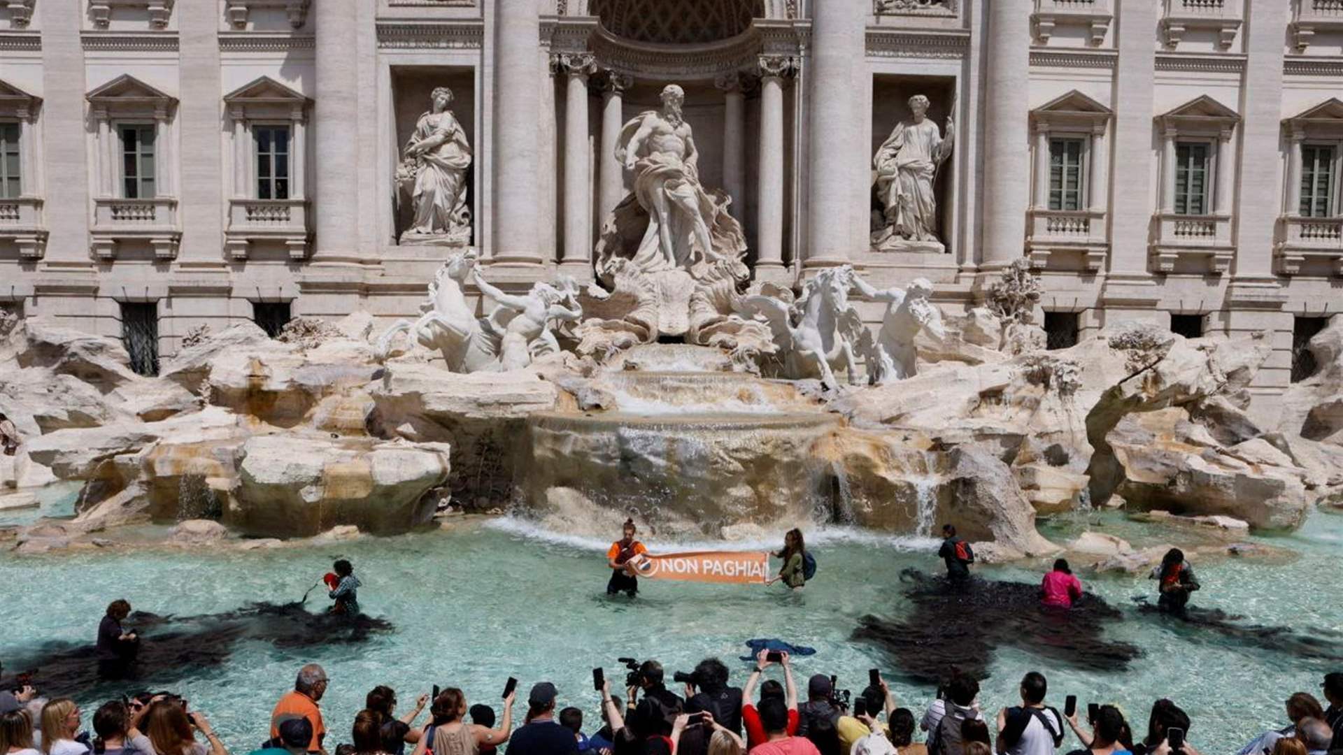 Trevi Fountain water turns black in Rome climate protest
