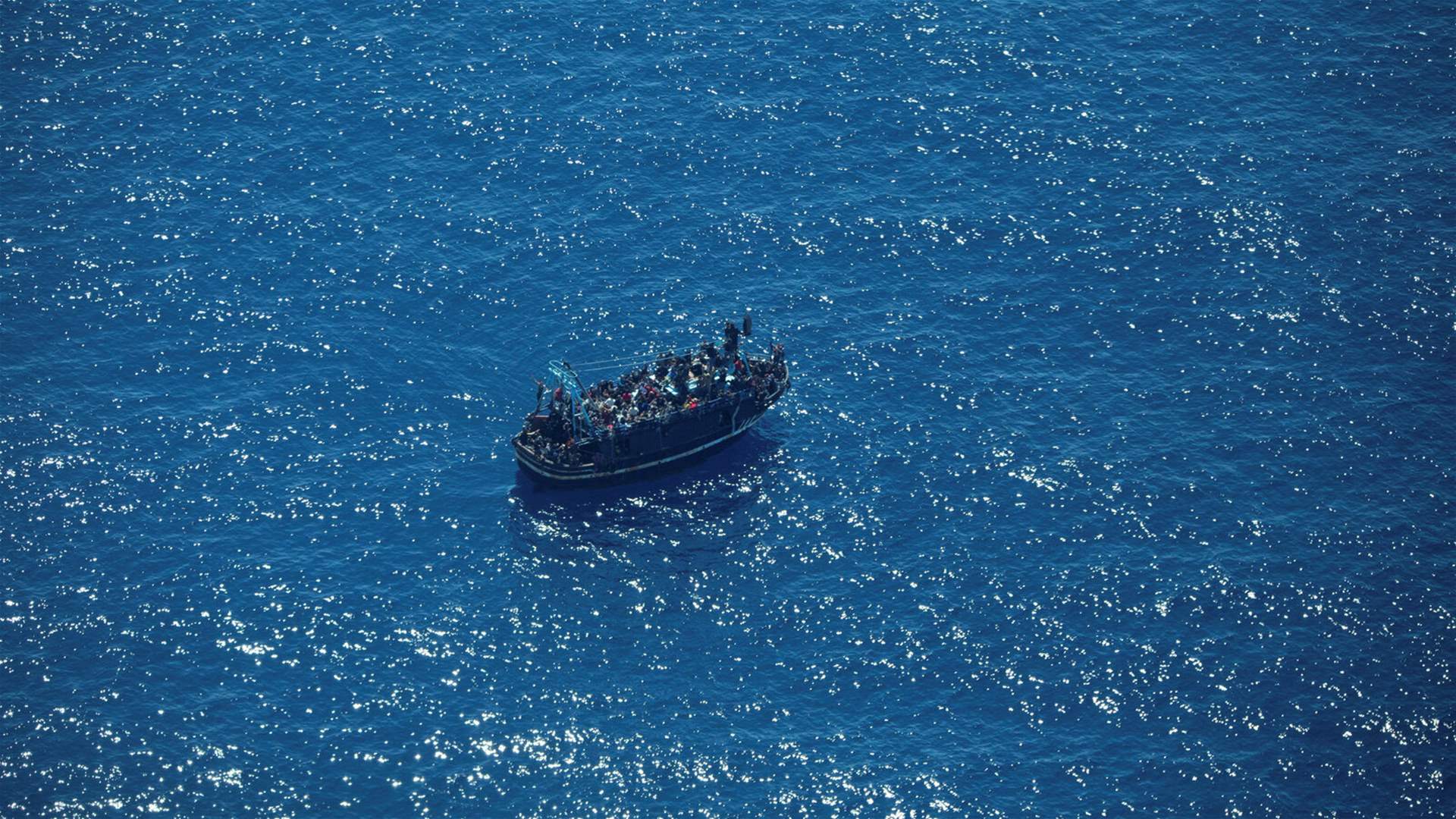 Rescue of dozens of migrants after fire erupts aboard an Italian ferry 