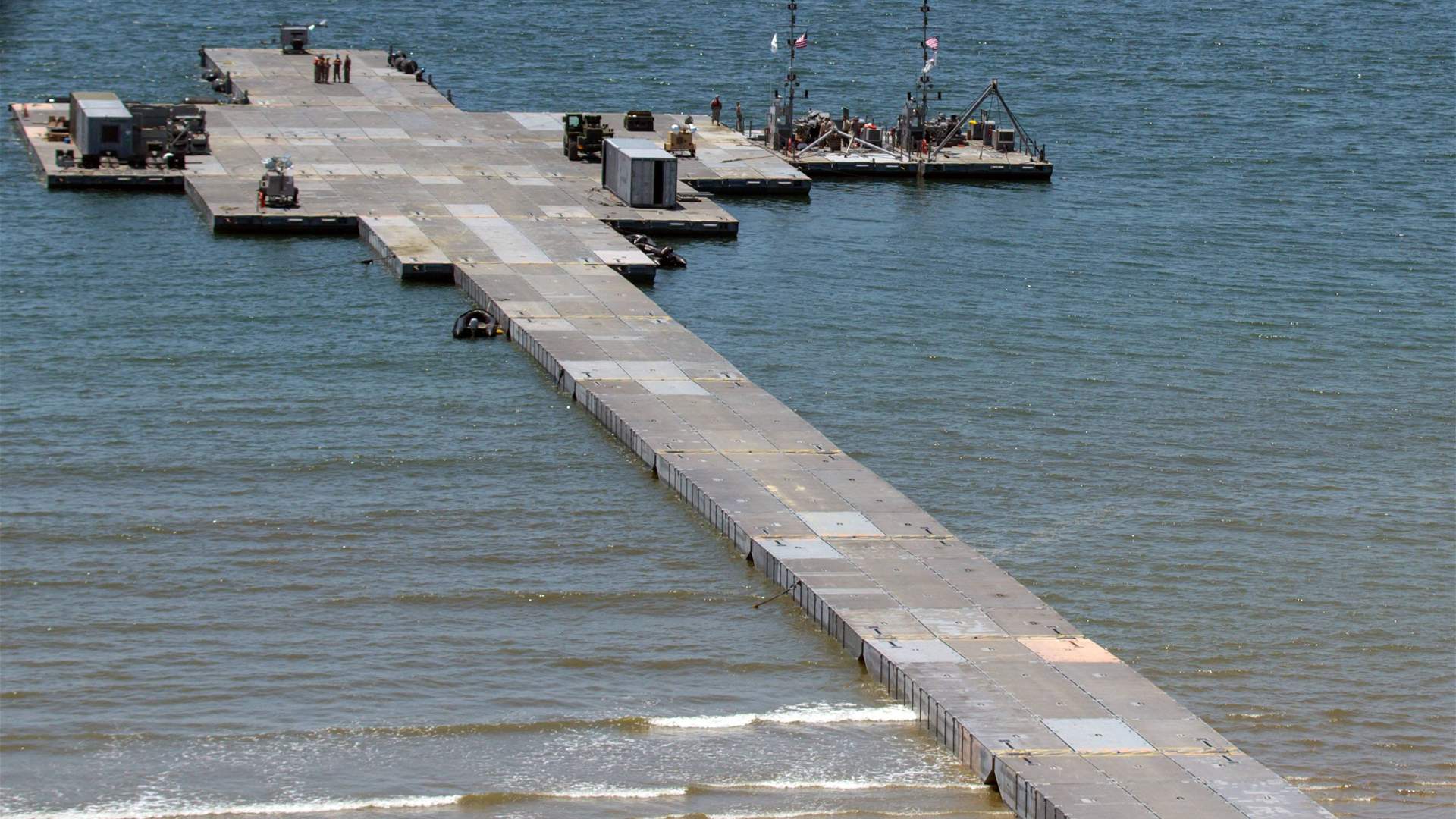 US says aid trucks begin moving ashore via Gaza pier