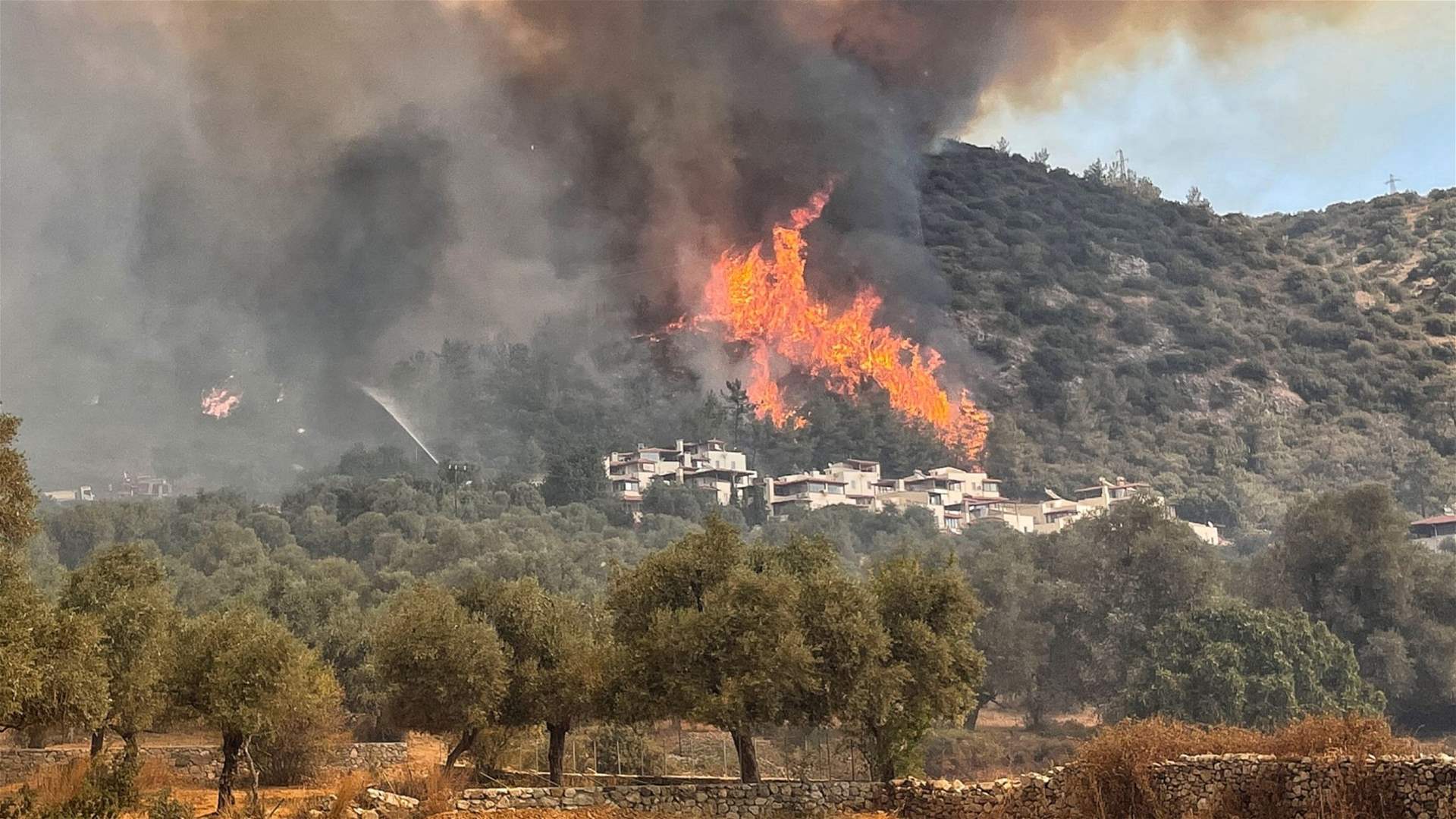 Firefighters battle to contain wildfires in Turkey