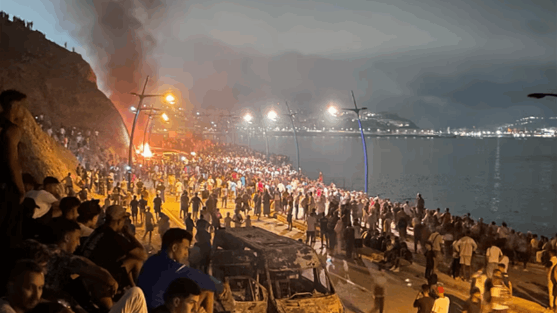 Sleepless night near border of Spain's Ceuta as migrants torch vehicles