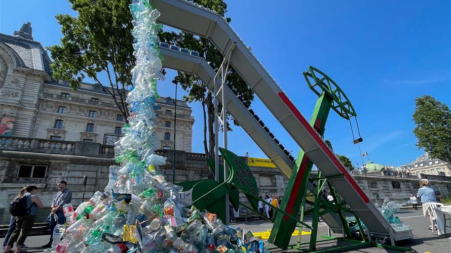 Plastic-spewing artwork unveiled for Paris talks against waste
