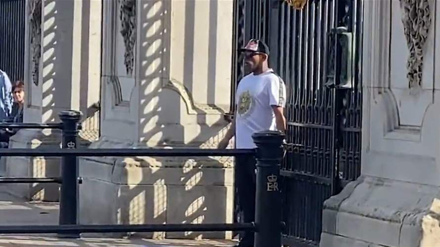 في مشهد غريب جداً... رجل يقيّد يديه في بوابات قصر باكنغهام (فيديو)