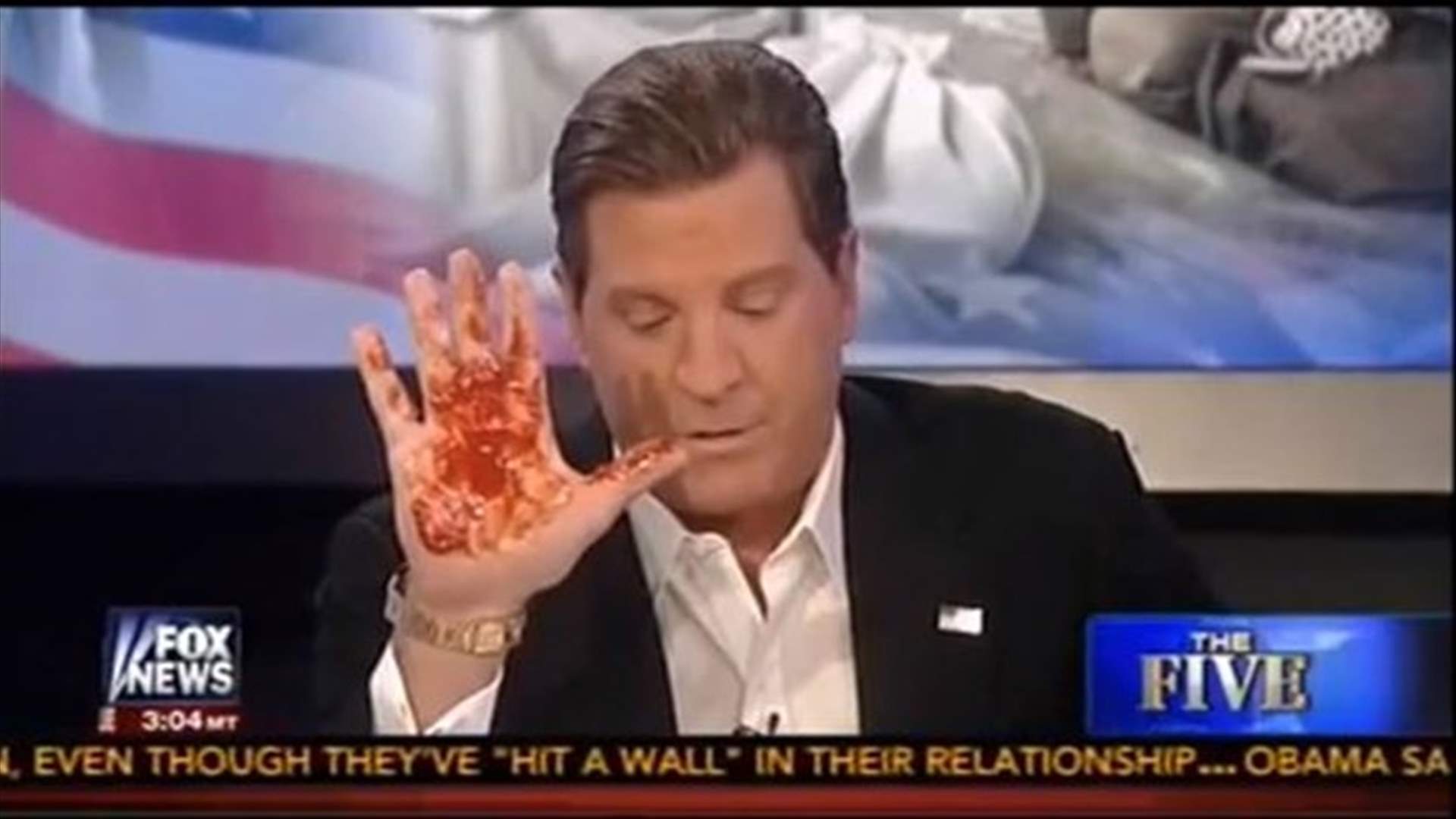 News host protests military action against Syria, raises “bloody hand” live on TV