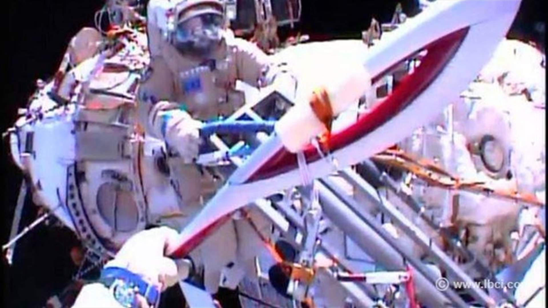 Olympic torch taken on first spacewalk