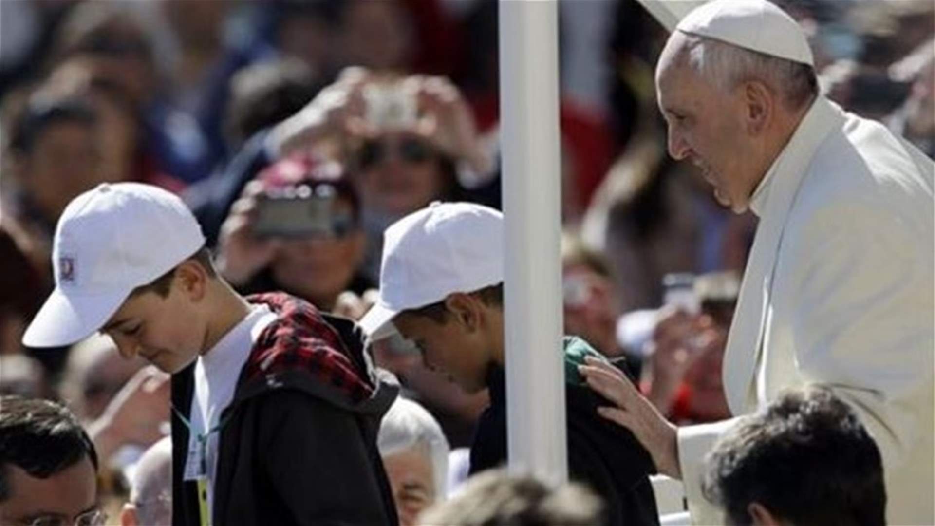 Pope gives a lift to 2 kids in St. Peter's Square