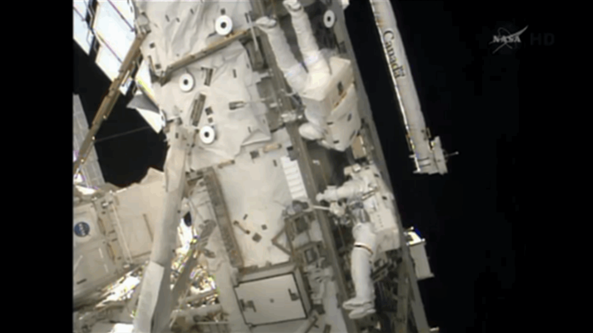 Spacewalkers replace failed computer outside space station 