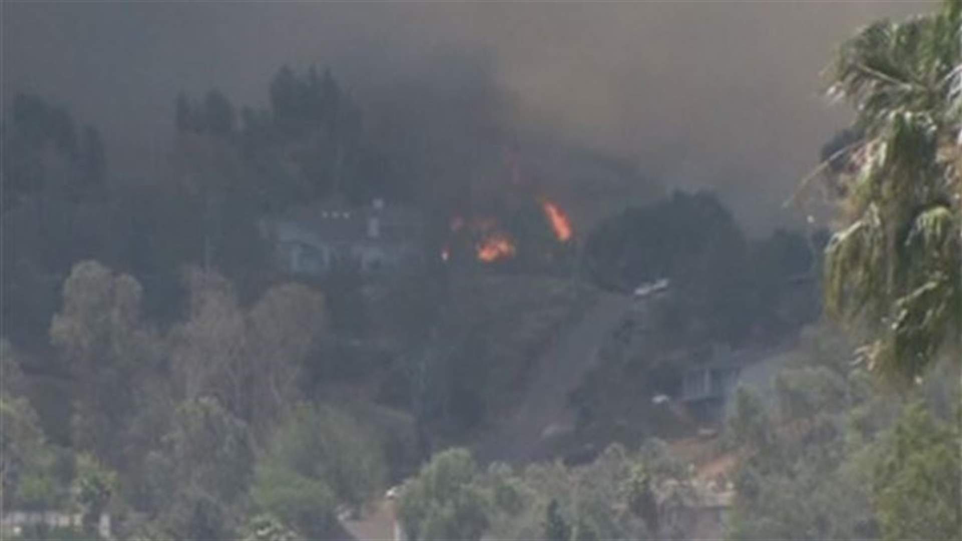 Southern California wildfires force 125,000 to flee, one dead