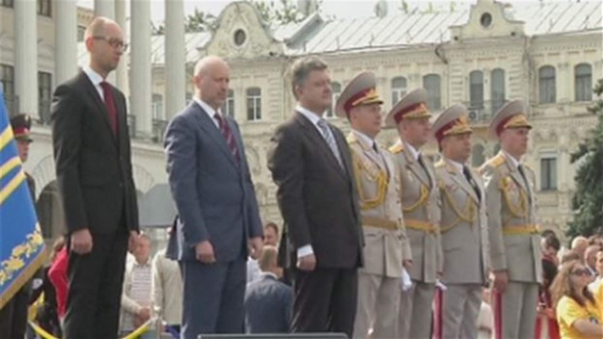 Ukraine marks defiant national day, rebels parade captives