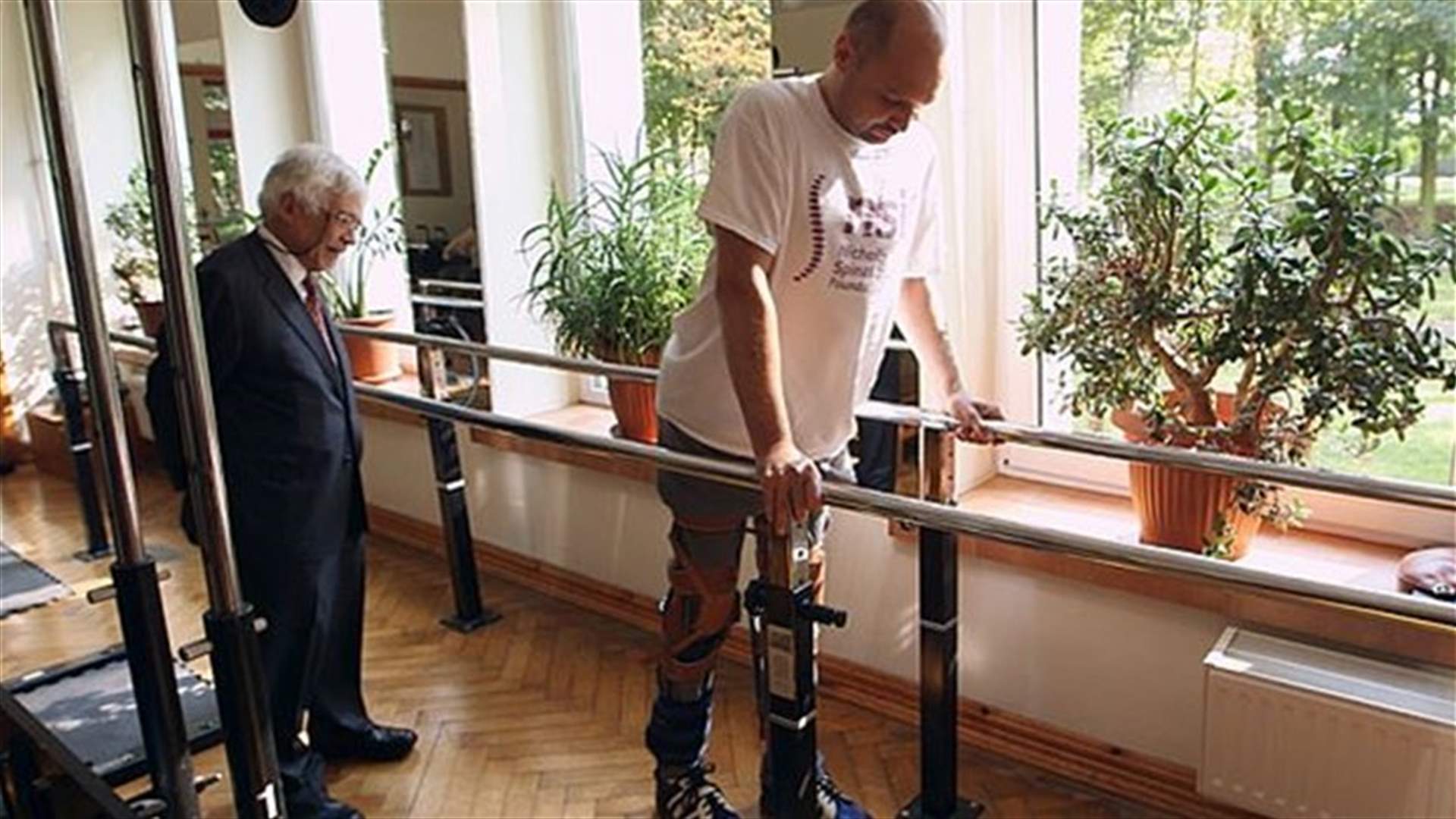 Cell transplant helps paralyzed man walk with frame