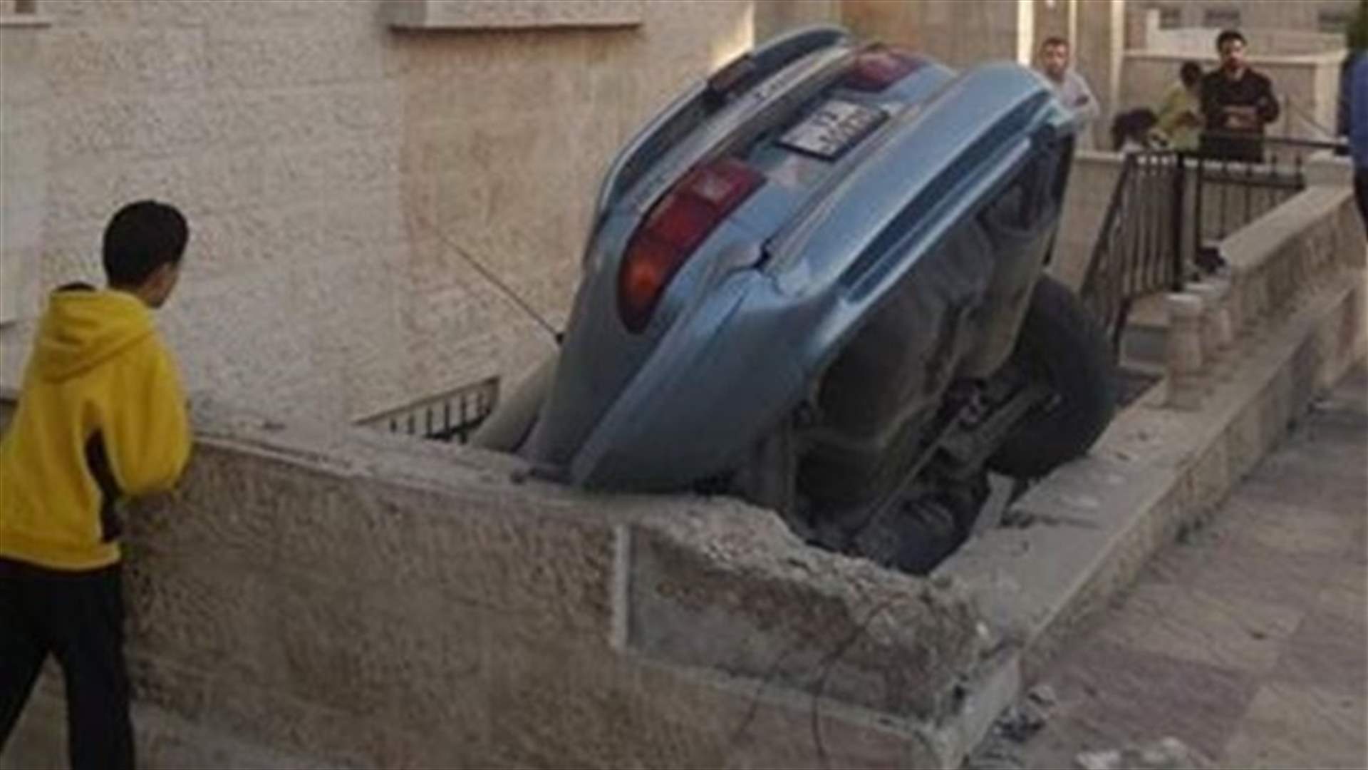بالصور: سقطت سيارته على شرفة أحد المنازل... والسبب امرأة