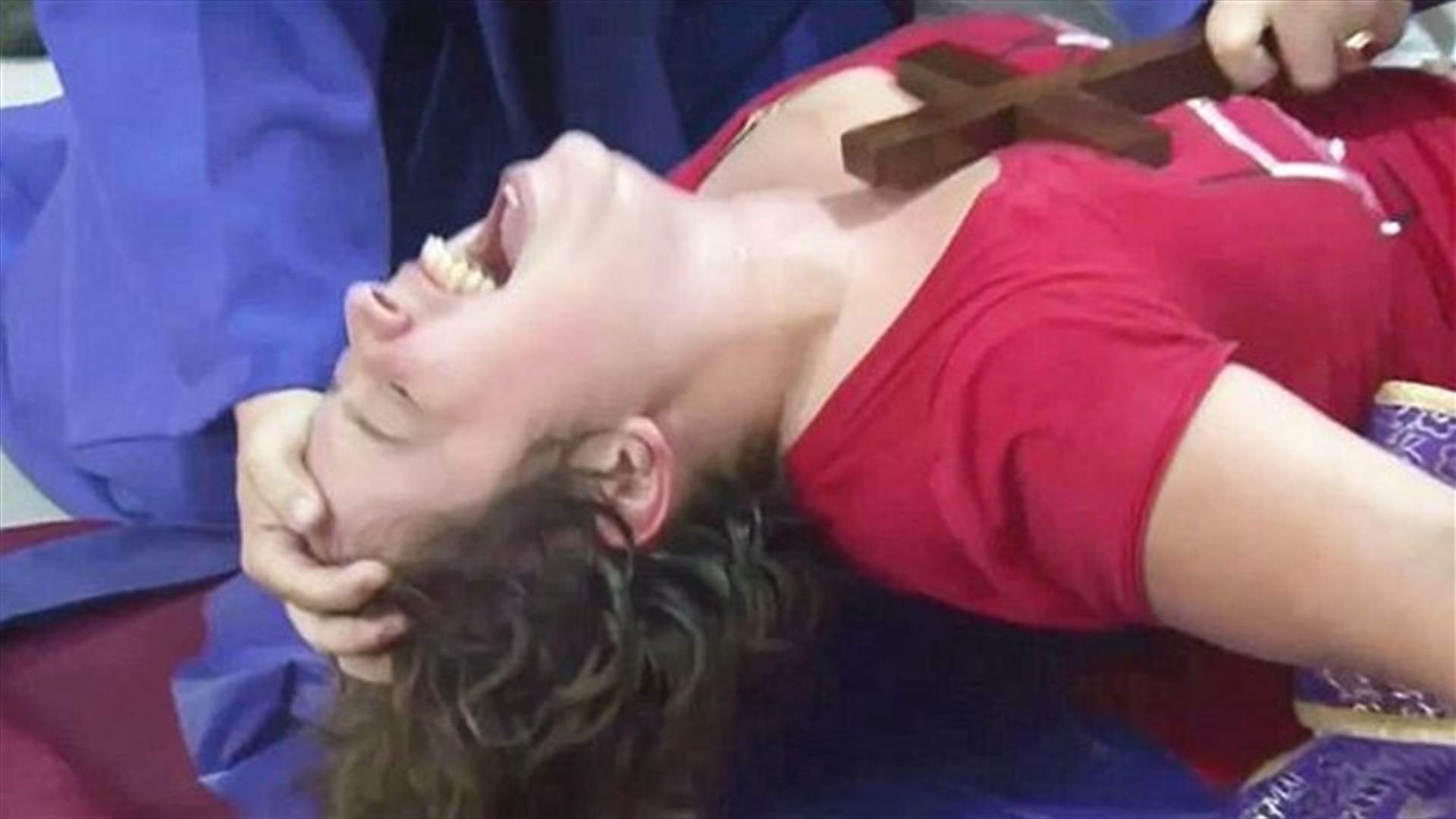 [VIDEO] Woman Pinned To The Ground Writhing In Pain As Priests Perform Exorcism
