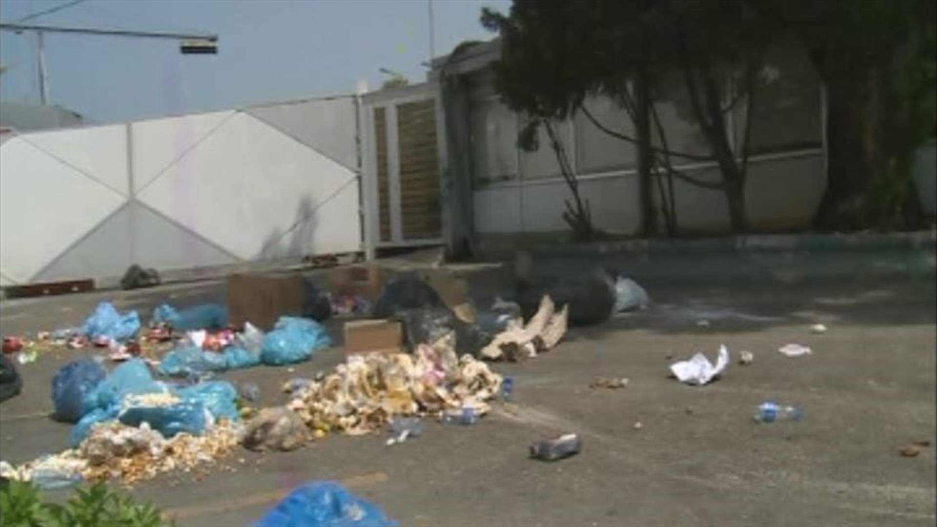 “We Want Accountability” activists dump garbage outside Sukleen Company 