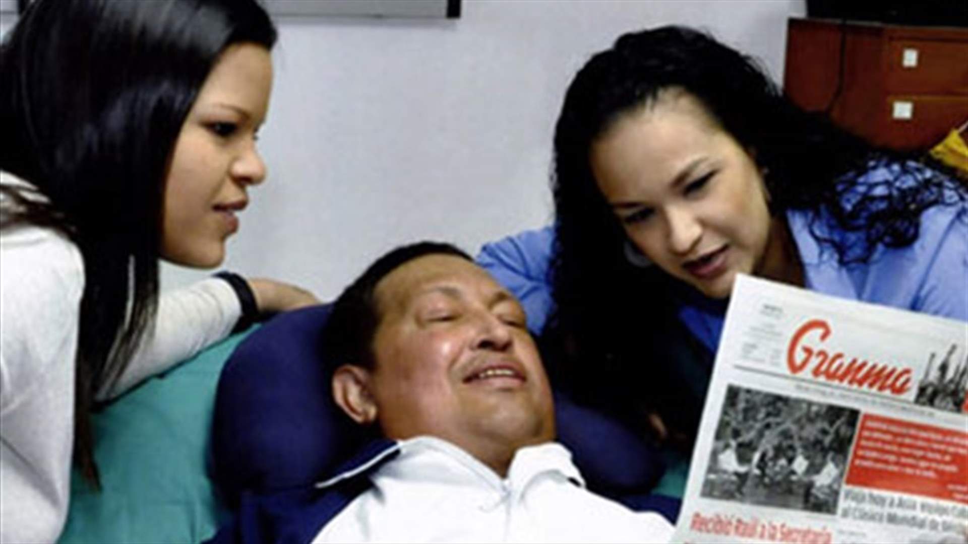 Venezuela shows photos of smiling Chavez reading newspaper