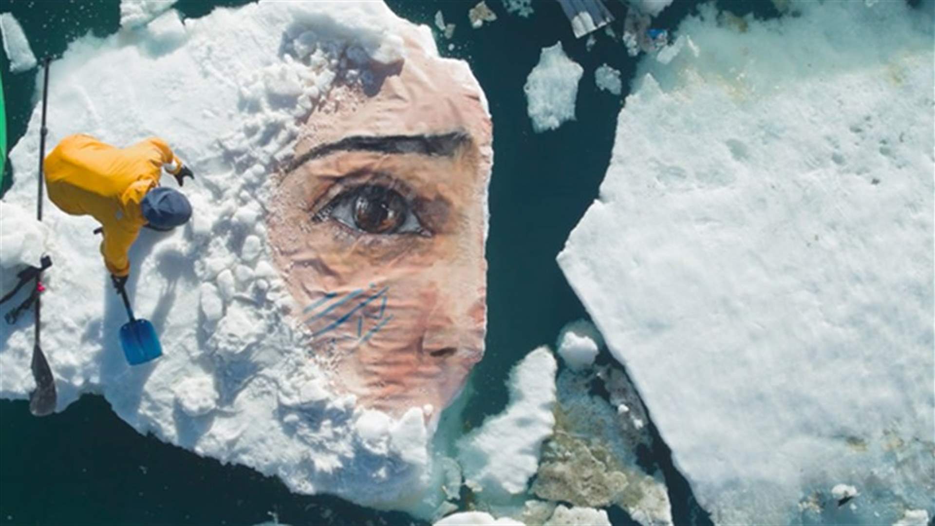[PHOTOS] Artist Races Against Time To Paint Mural On Melting Iceberg