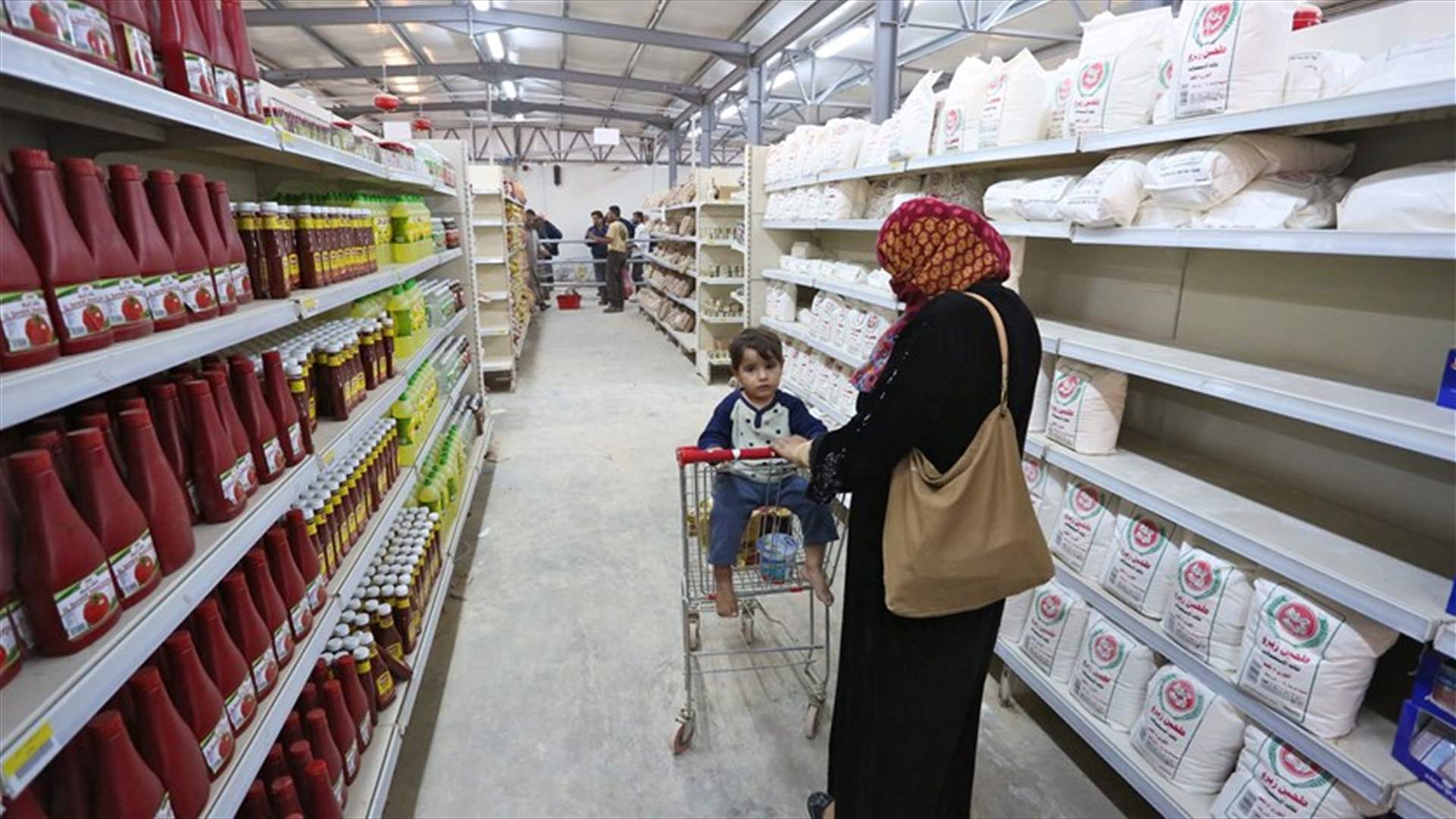 At Zaatari camp supermarket, Syrian refugees shop with blink of an eye