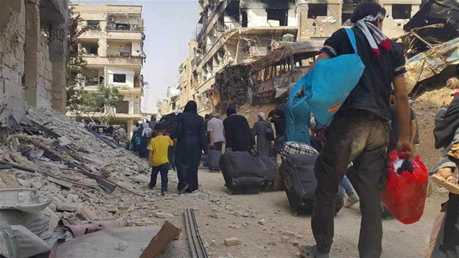 Syrian rebels, families evacuate besieged town near Damascus