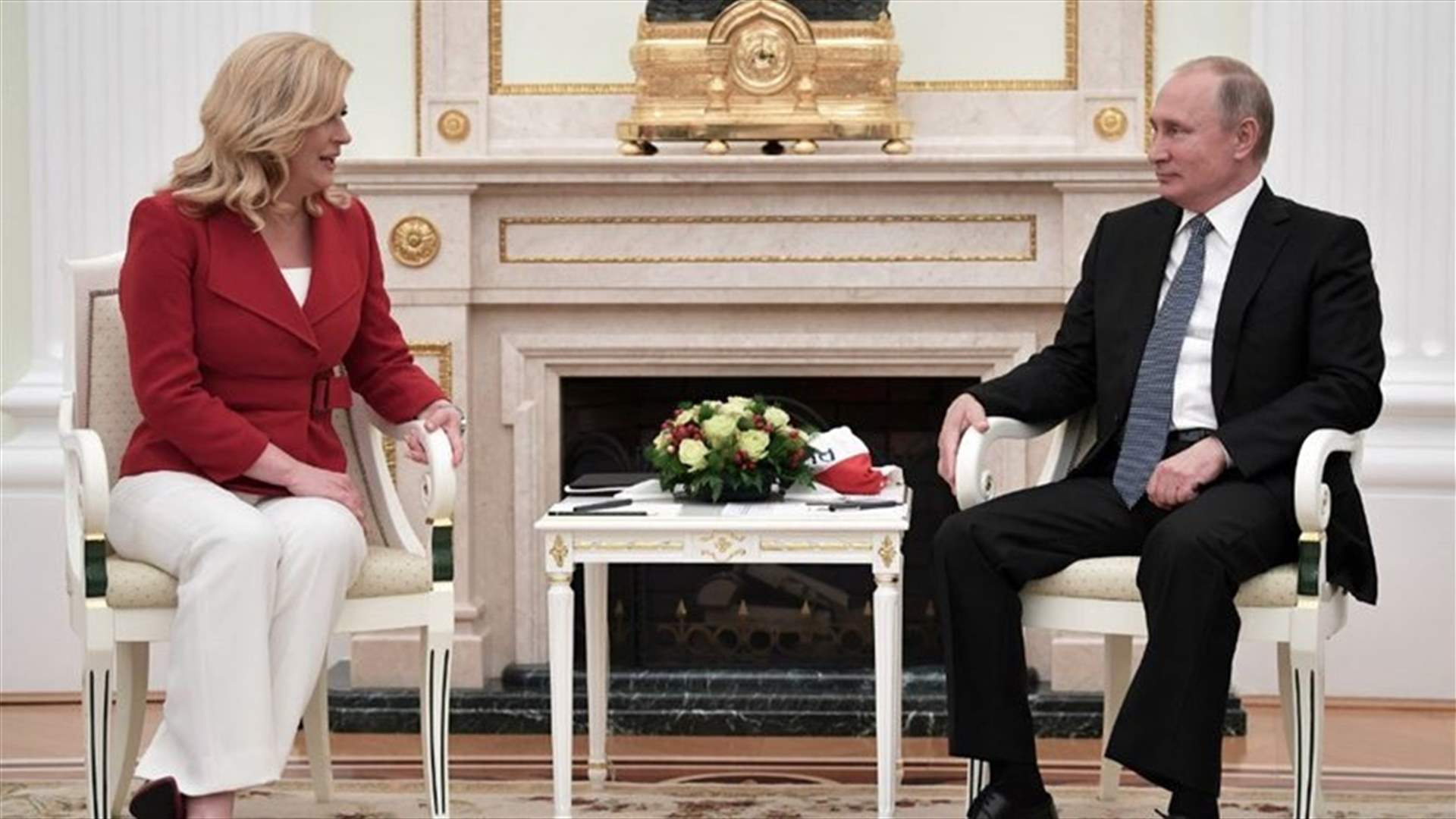 Croatian leader hands Putin soccer shirt before World Cup final