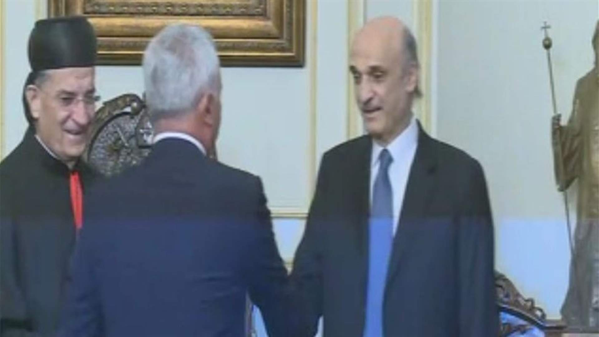 Frangieh and Geagea shake hands before the start of the reconciliation meeting in Bkerke