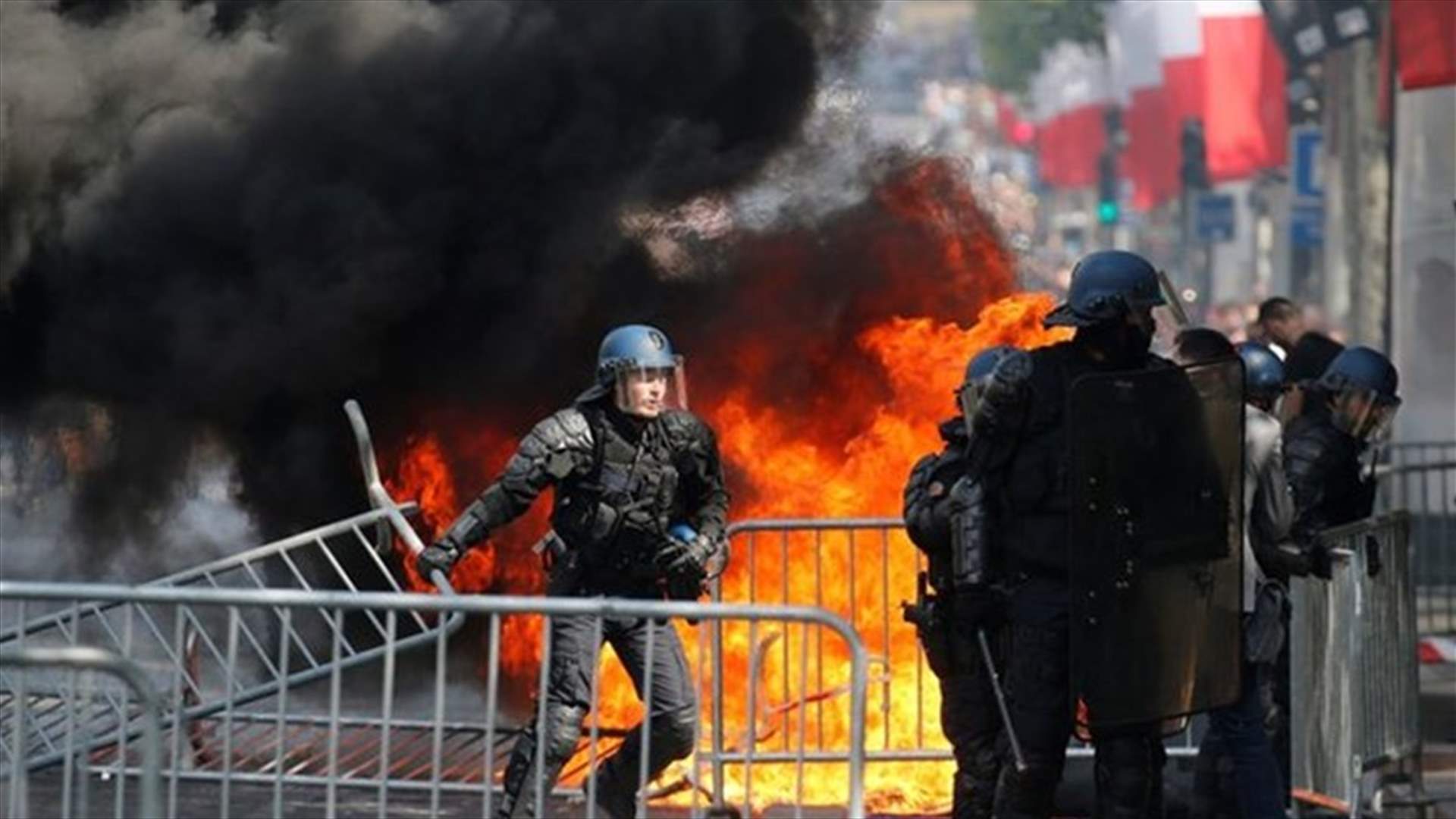 French police fire tear gas as protests follow Bastille Day parade