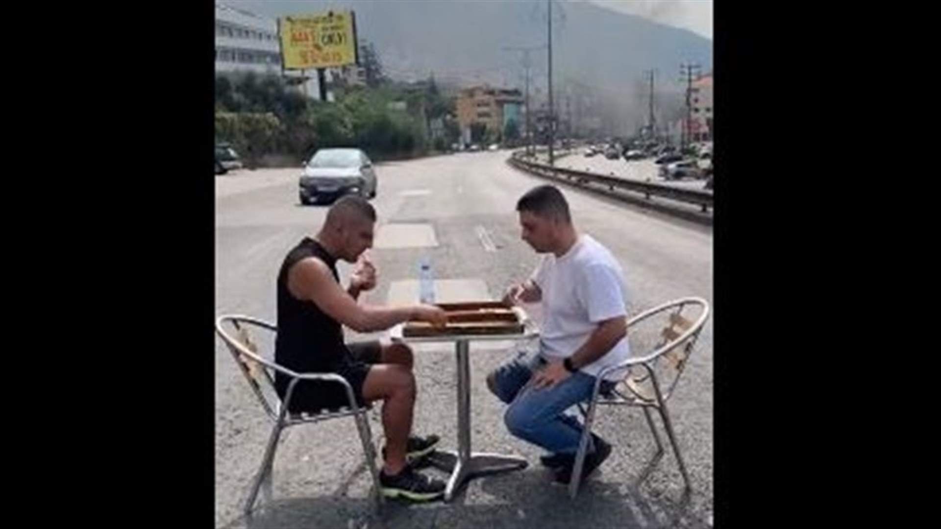 Citizens play board game in the middle of Ghazir highway
