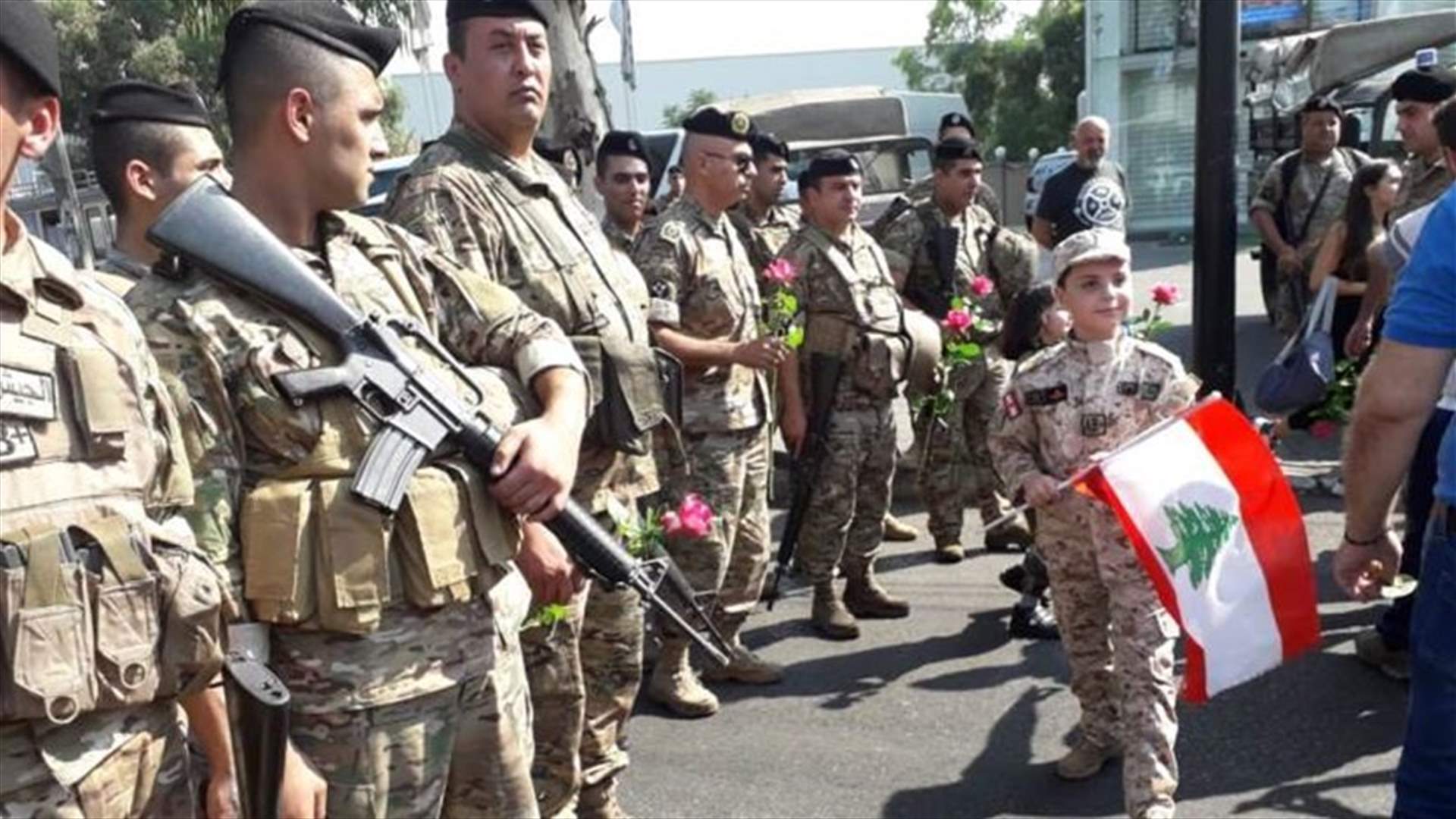 Protesters distribute roses to army soldiers in Ain al-Remmaneh