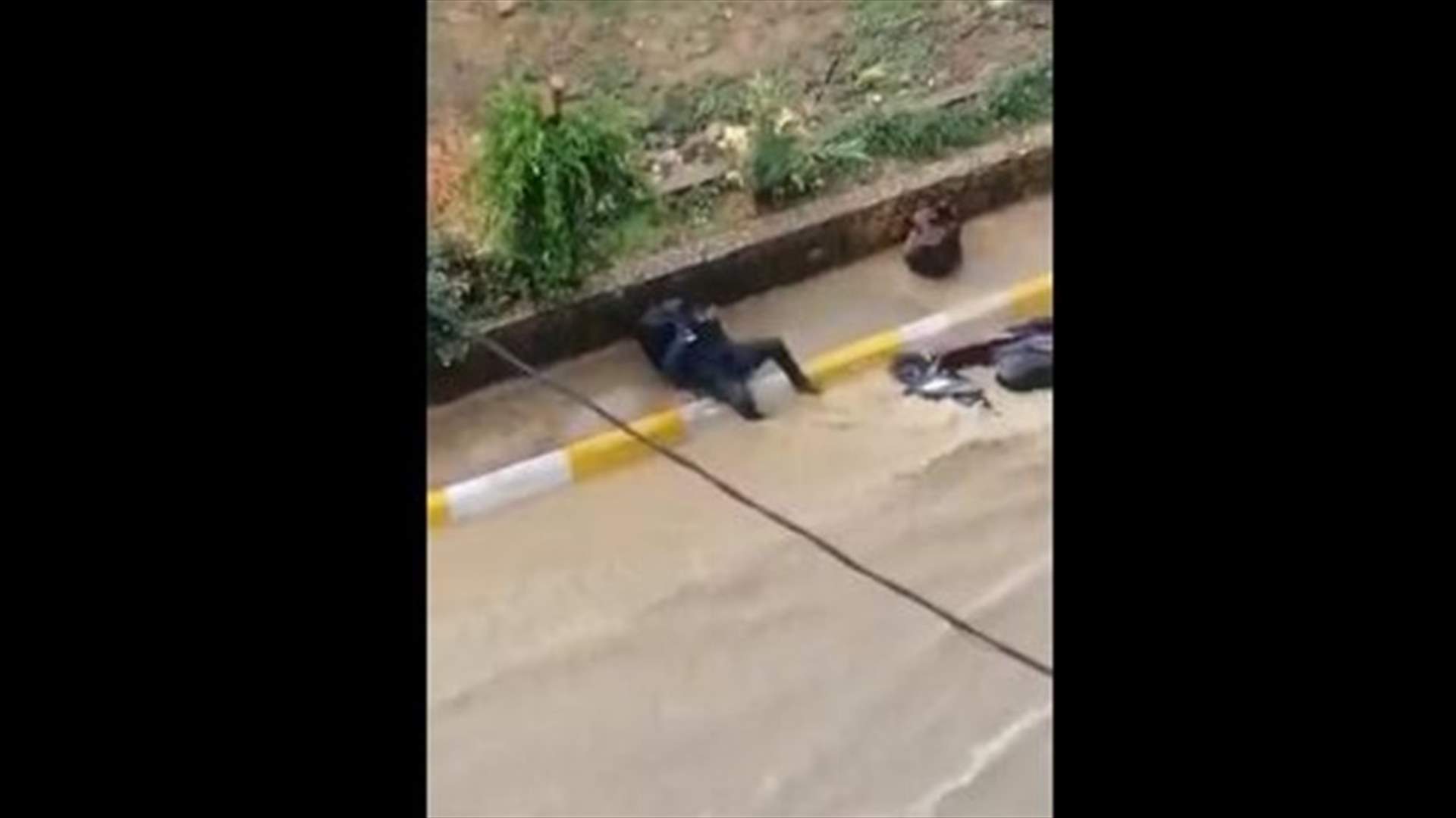 Motorcycle swept away in floods after rider falls off (Video)