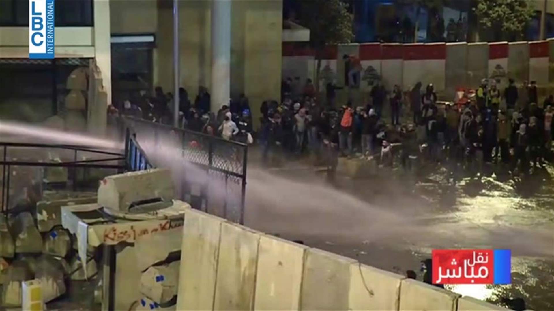 Lebanese security fire water cannons at protesters breaching barricade