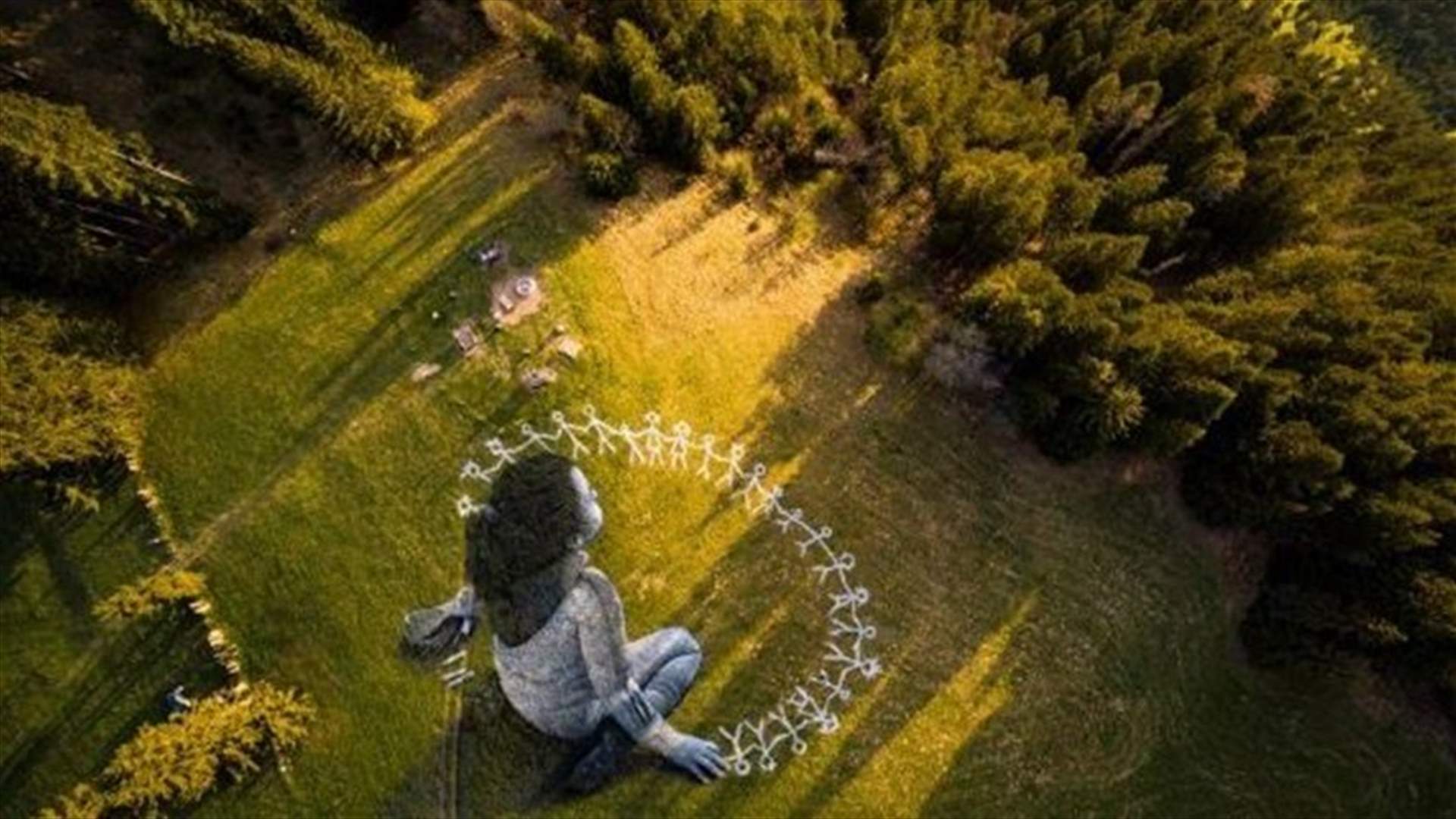 Massive coronavirus-themed grass graffiti is unveiled in Swiss Alps-[PHOTO]