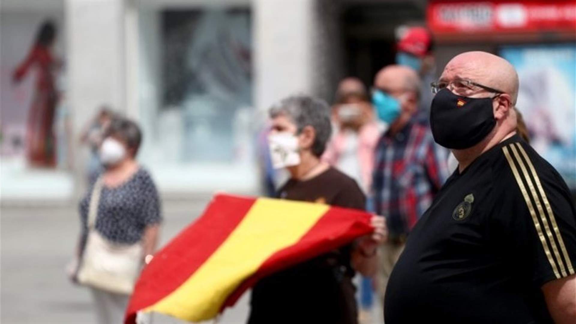 With black masks and silence, Spain mourns its coronavirus dead