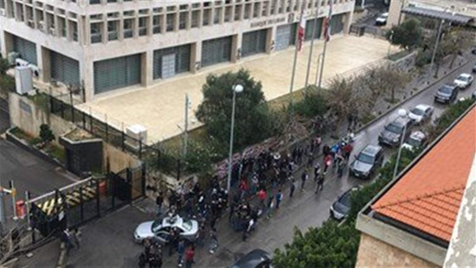 Protesters set garbage containers on fire outside Central Bank in Hamra