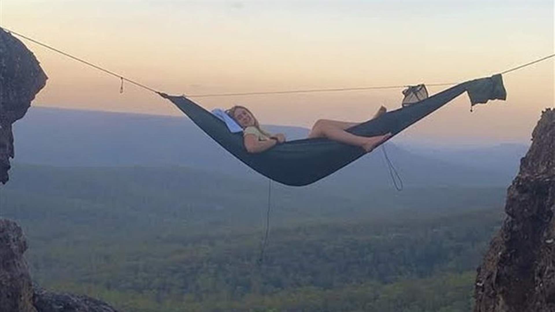 مغامرة تخطف الأنفاس... شاب وشقيقته ينامان على أرجوحة شبكية بين الجبال على ارتفاع 21 متراً (صور)