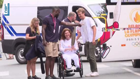 AFP journalists Christina Assi and Dylan Collins carry the Olympic Flame