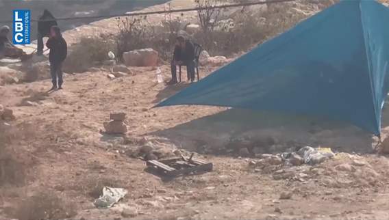 Loay returns home while settlers wait at the entrance